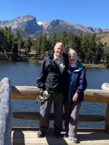 Galen and Beth Miller at Sprague Lake in Rocky Mountain National Park with Hallett and Flattop Peaks in the background.