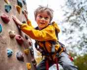 Young boy on a climbing wall.