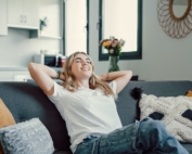 Teen girl relaxing and smiling on the sofa.