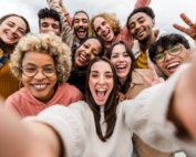 Group of teens smiling and laughing.