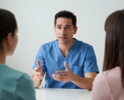 Staff member discussing things with two females, one is probably a patient.